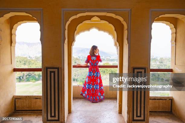 the baradhari pavilion in jaipur is situated at man singh palace square, and a young woman is standing in front of amber fort. - udaipur museum stock pictures, royalty-free photos & images