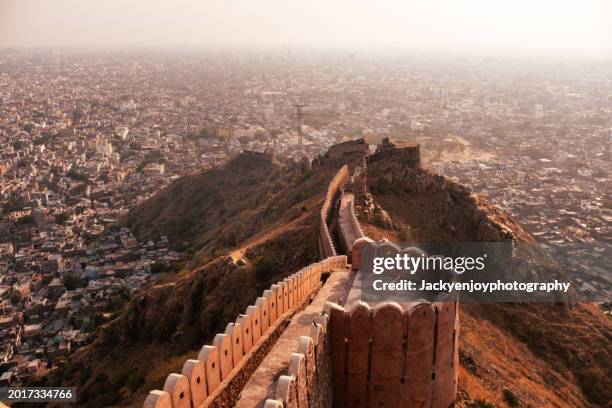 in the centre of jaipur, india, the nahargarh fort's palace and ancient mugal walls make for a stunning sunset backdrop. - palace stock pictures, royalty-free photos & images