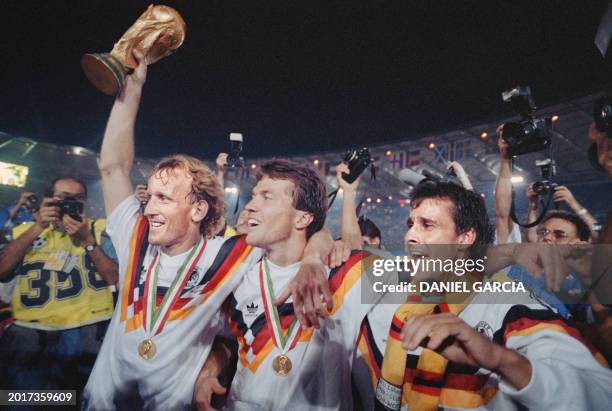 From left, West German defender Andreas Brehme, captain Lothar Matthaeus and Pierre Littbarski celebrate the victory during the World Cup final...