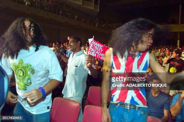 Cubans dance to the music of the British rock band Manic Street Preachers, 17 February, 2001 at the Karl Marx theater in Havana. The group kicked off...
