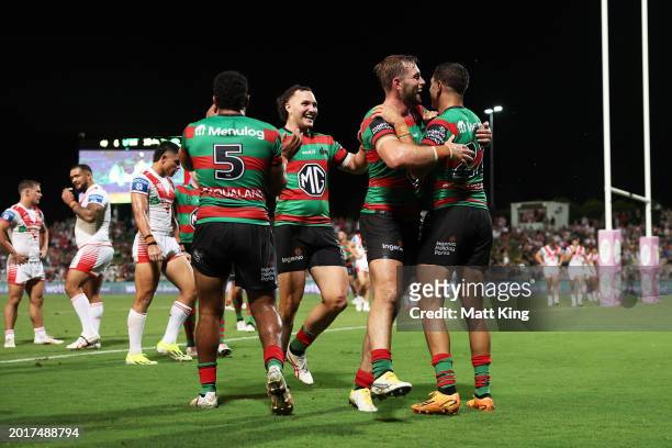 Braidon Burns of the Rabbitohs celebrates with team mates after scoring a try during the NRL Pre-Season Challenge round one match between St George...