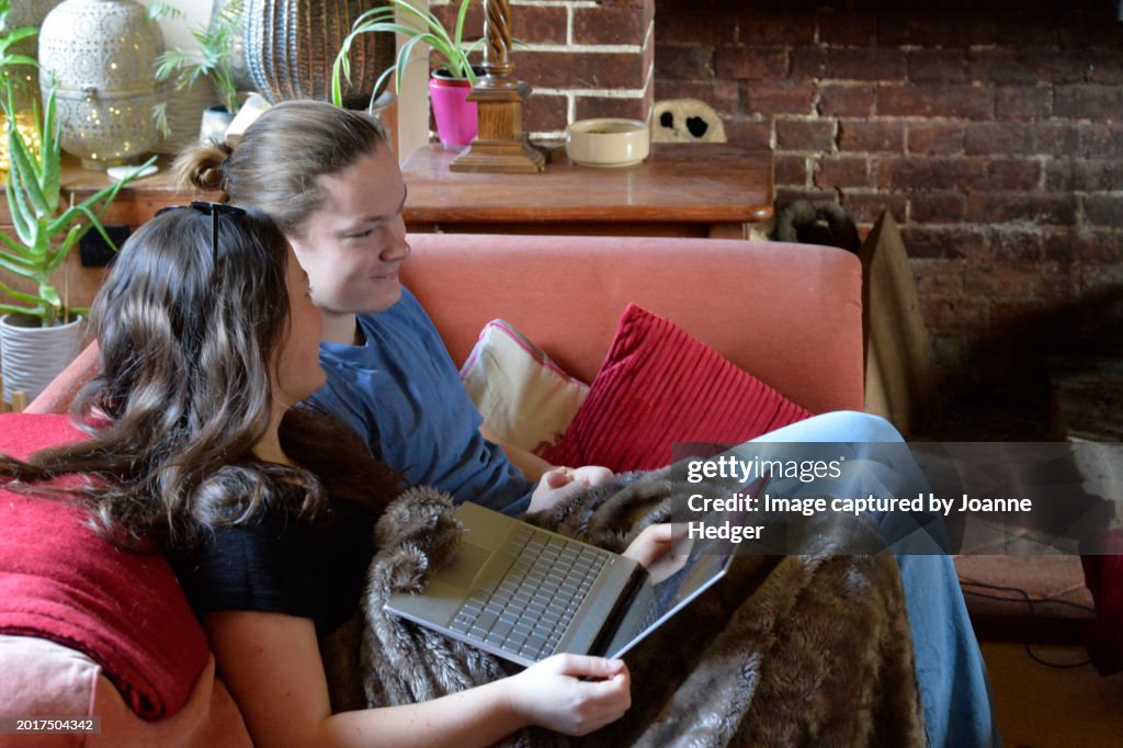 Two Teenagers On The Sofa Using Technology To Communicate High-Res ...