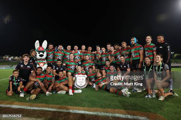 The Rabbitohs celebrate victory and pose with the Charity Shield during the NRL Pre-Season Challenge round one match between St George Illawarra...