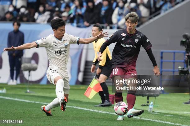 Yuichi Maruyama of Kawasaki Frontale and Yuya Osako of Vissel Kobe compete for the ball during the FUJIFLIM SUPER CUP match between Vissel Kobe and...
