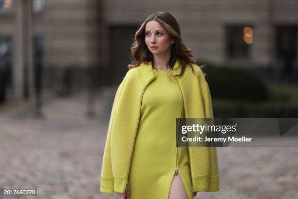 Anna Hiltrop seen wearing Escada yellow / lime green zip midi dress, matching Escada yellow / lime green wool short coat / bomber jacket, on February...