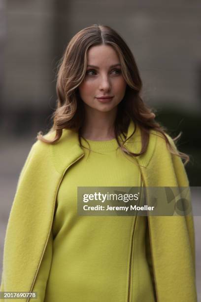 Anna Hiltrop seen wearing Escada yellow / lime green zip midi dress, matching Escada yellow / lime green wool short coat / bomber jacket, on February...