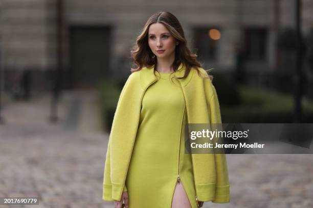 Anna Hiltrop seen wearing Escada yellow / lime green zip midi dress, matching Escada yellow / lime green wool short coat / bomber jacket, on February...