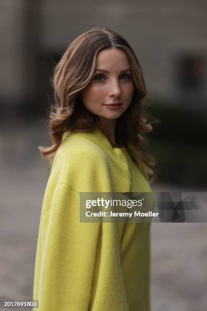 Anna Hiltrop seen wearing Escada yellow / lime green zip midi dress, matching Escada yellow / lime green wool short coat / bomber jacket, on February...