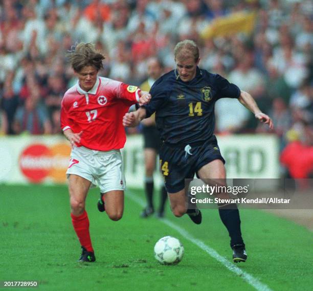 June 18: Gordon Durie of Scotland and Johann Vogel of Switzerland challenge during the UEFA Euro 1996 Group A match between Scotland and Switzerland...