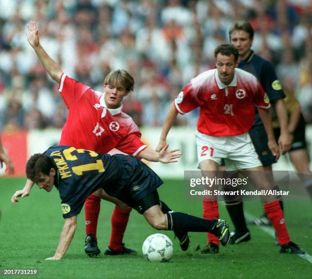 June 18: Johann Vogal of Switzerland and Tosh Mckinlay of Scotland challenge during the UEFA Euro 1996 Group A match between Scotland and Switzerland...