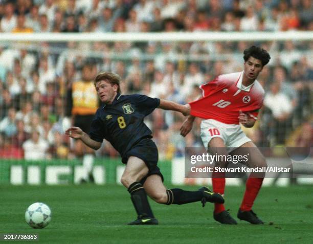 June 18: Stuart Mccall of Scotland and Ciriaco Sforza of Switzerland challenge during the UEFA Euro 1996 Group A match between Scotland and...