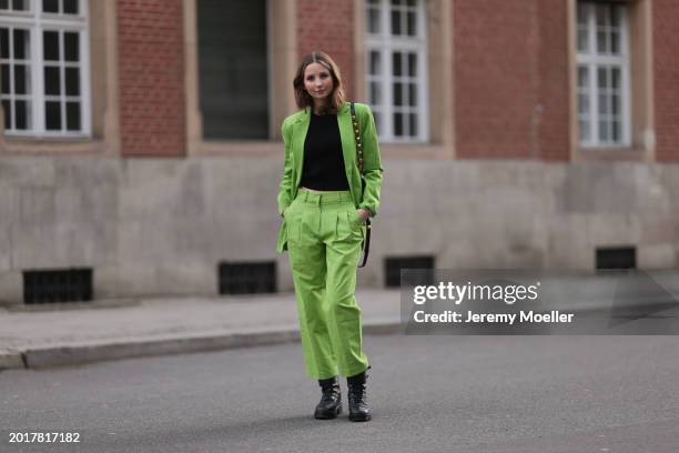 Anna Hiltrop seen wearing Michael Kors light green suit blazer jacket, matching Michael Kors light green suit long pants, black basic cotton top,...