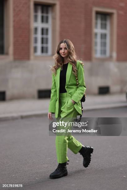 Anna Hiltrop seen wearing Michael Kors light green suit blazer jacket, matching Michael Kors light green suit long pants, black basic cotton top,...