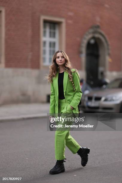 Anna Hiltrop seen wearing Michael Kors light green suit blazer jacket, matching Michael Kors light green suit long pants, black basic cotton top,...