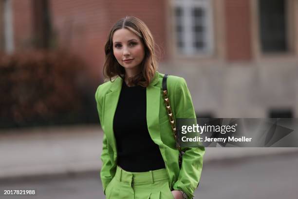 Anna Hiltrop seen wearing Michael Kors light green suit blazer jacket, matching Michael Kors light green suit long pants, black basic cotton top,...