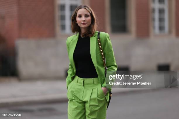 Anna Hiltrop seen wearing Michael Kors light green suit blazer jacket, matching Michael Kors light green suit long pants, black basic cotton top,...