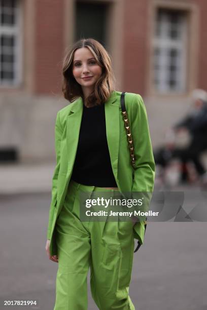 Anna Hiltrop seen wearing Michael Kors light green suit blazer jacket, matching Michael Kors light green suit long pants, black basic cotton top,...