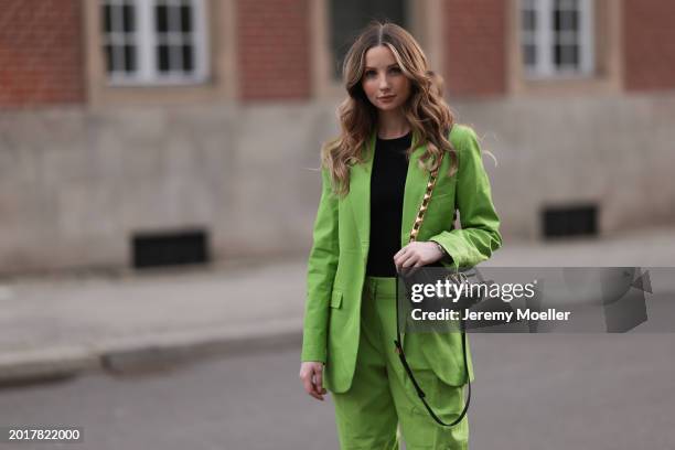 Anna Hiltrop seen wearing Michael Kors light green suit blazer jacket, matching Michael Kors light green suit long pants, black basic cotton top,...