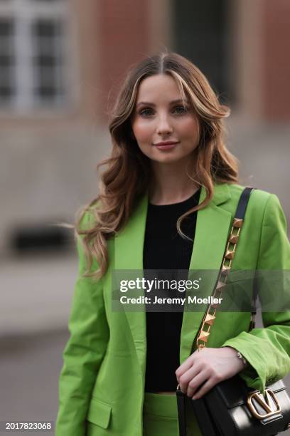 Anna Hiltrop seen wearing Michael Kors light green suit blazer jacket, matching Michael Kors light green suit long pants, black basic cotton top,...