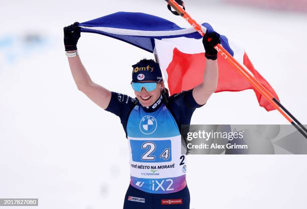 Julia Simon of France celebrates as she crosses the finish line, whilst waving a French National Flag, during the Women's Relay in the IBU World...