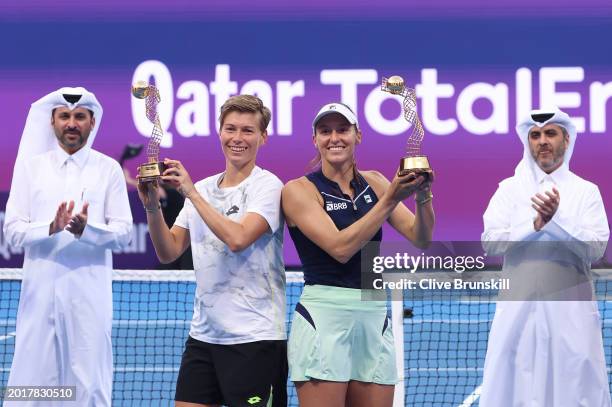 Demi Schuurs of the Netherlands and Luisa Stefani of Brazil hold aloft their winners trophies after their straight sets victory against Desirae...