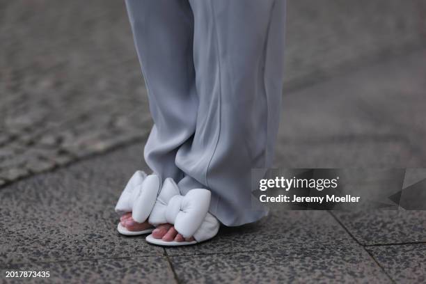 Anna Hiltrop seen wearing Escada light grey satin long pants,and Off White white leather bow detailed heels, on February 16, 2024 in Berlin, Germany.