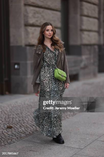 Anna Hiltrop seen wearing Boss green / beige / black print pattern pleated long dress, Boss brown suede leather jacket, Michael Kors green leather...