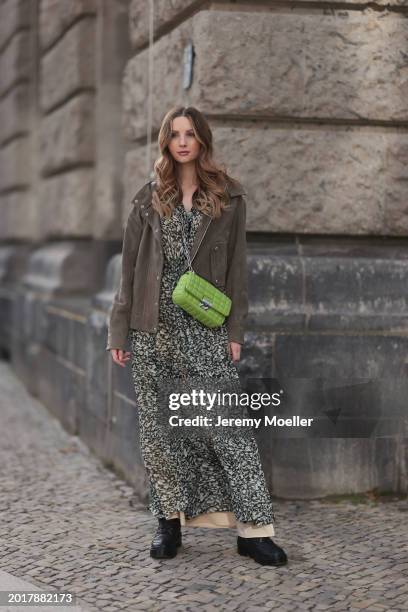 Anna Hiltrop seen wearing Boss green / beige / black print pattern pleated long dress, Boss brown suede leather jacket, Michael Kors green leather...