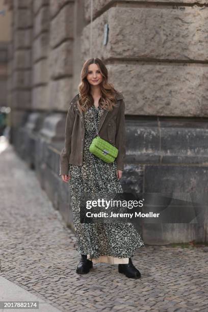 Anna Hiltrop seen wearing Boss green / beige / black print pattern pleated long dress, Boss brown suede leather jacket, Michael Kors green leather...