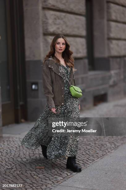 Anna Hiltrop seen wearing Boss green / beige / black print pattern pleated long dress, Boss brown suede leather jacket, Michael Kors green leather...