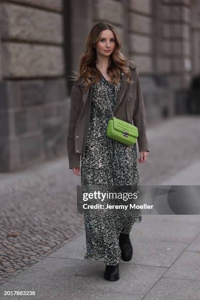 Anna Hiltrop seen wearing Boss green / beige / black print pattern pleated long dress, Boss brown suede leather jacket, Michael Kors green leather...