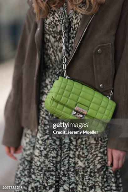 Anna Hiltrop seen wearing Boss green / beige / black print pattern pleated long dress, Boss brown suede leather jacket and Michael Kors green leather...