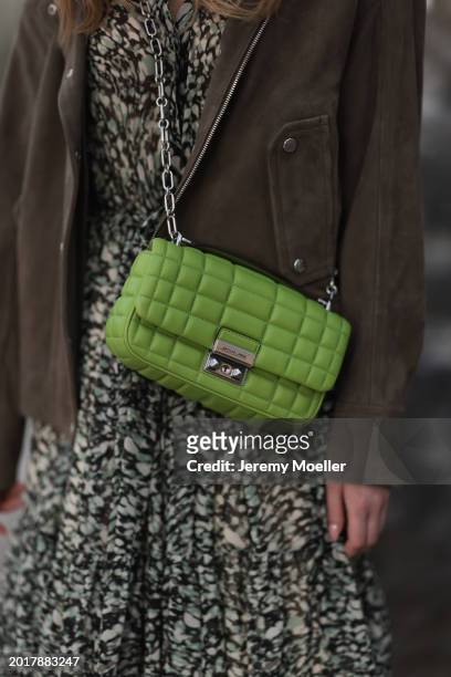 Anna Hiltrop seen wearing Boss green / beige / black print pattern pleated long dress, Boss brown suede leather jacket and Michael Kors green leather...