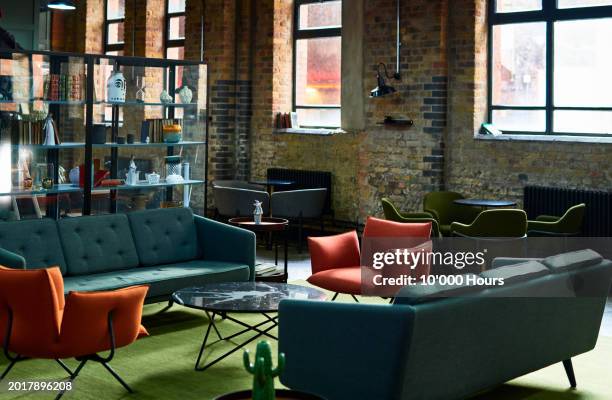empty co-working space with sofas - coworking foto e immagini stock