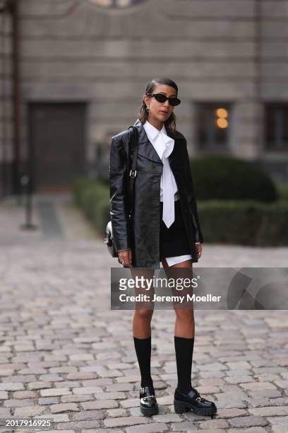 Rabea Schif seen wearing Prada black oval shaped sunglasses, Chanel gold earrings, Vintage black leather jacket, Peter Petrov black short skirt,...