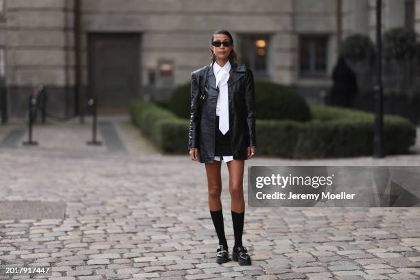 Rabea Schif seen wearing Prada black oval shaped sunglasses, Chanel gold earrings, Vintage black leather jacket, Peter Petrov black short skirt,...