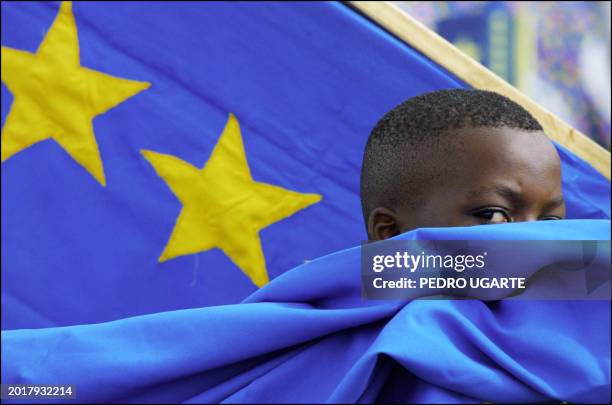 Congolese child waits to welcome Democratic Republlic of Congo's president, Joseph Kabila at Arusha airport, in Tanzania, 26 February 2001. A new...