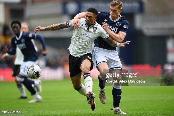 Liam Palmer of Sheffield Wednesday battles for possession with Zian Flemming of Millwall during the Sky Bet Championship match between Millwall and...
