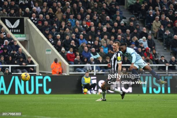 Antoine Semenyo of AFC Bournemouth scores his team's second goal under pressure from Dan Burn of Newcastle United during the Premier League match...