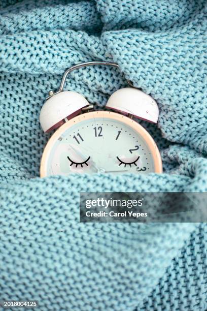 pink alarm clock sleeping in bed - daylight saving time stock pictures, royalty-free photos & images