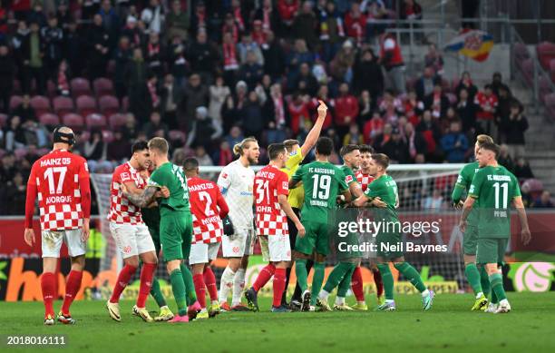 Mads Pedersen of FC Augsburg receives a red card from referee Tobias Reichel during the Bundesliga match between 1. FSV Mainz 05 and FC Augsburg at...