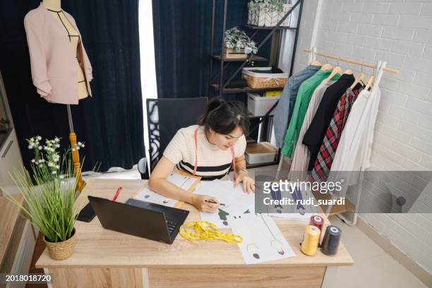 wedding dress designer working - design studio woman chinese laptop stock pictures, royalty-free photos & images