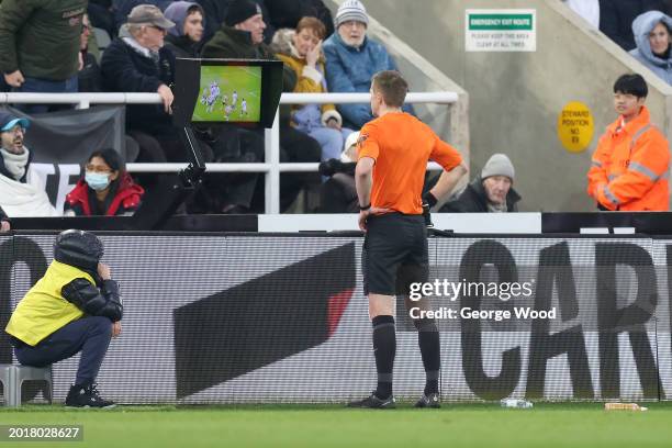Referee Michael Salisbury reviews the Video Assistant Referee monitor during the Premier League match between Newcastle United and AFC Bournemouth at...