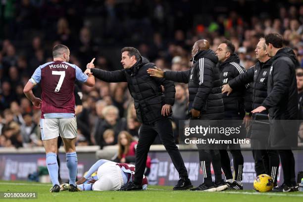 Marco Silva, Manager of Fulham, speaks to John McGinn of Aston Villa during the Premier League match between Fulham FC and Aston Villa at Craven...
