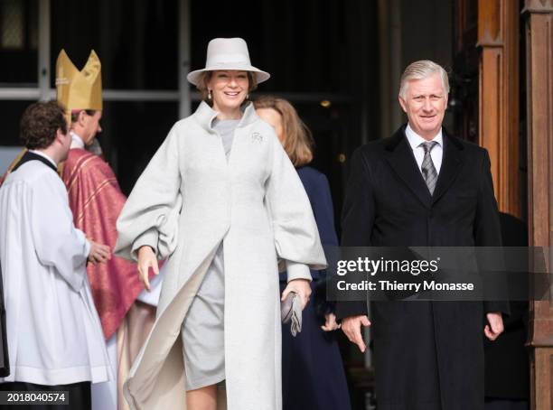 Queen Mathilde of Belgium and the King Philippe of Belgium walk out at the end of the annual mass at the Notre-Dame church in Laeken, in memory of...