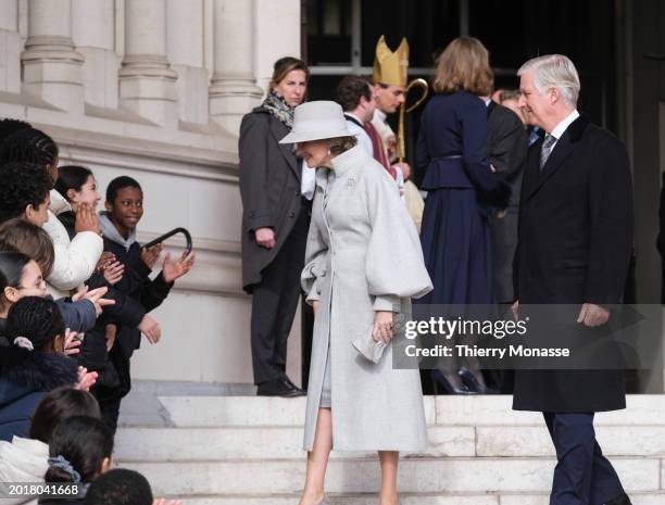 Queen Mathilde of Belgium and the King Philippe of Belgium talk with children at the end of the annual mass at the Notre-Dame church in Laeken, in...