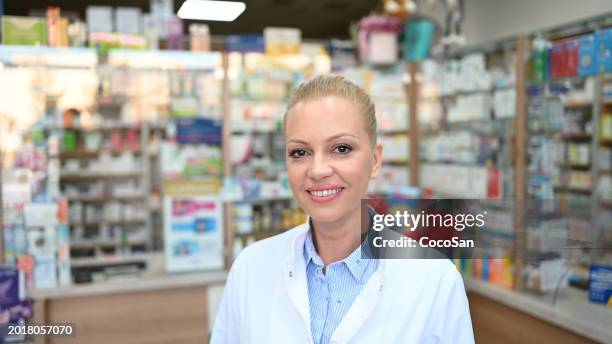 female pharmacist serving the customer - coco stock pictures, royalty-free photos & images