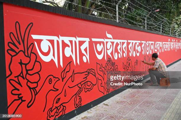 Bangladeshi fine arts students and teachers paint on a wall in front of the Central Shahid Minar in Dhaka on February 20 as part of preparations for...