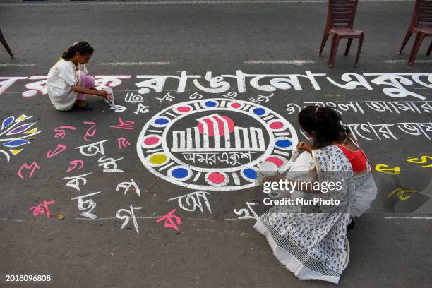 Mother and daughter are drawing various graffiti on the street in Kolkata, India, on February 20 ahead of the International Mother Language Day...