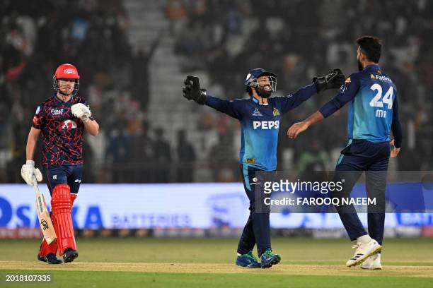 Multan Sultans' Mohammad Rizwan celebrates with teammate Usama Mir the wicket of Islamabad United's Jordan Cox walks back during the Pakistan Super...